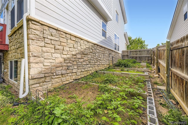 15649 E 7th Cir, Aurora, CO 80011 - fenced backyard with a vegetable garden