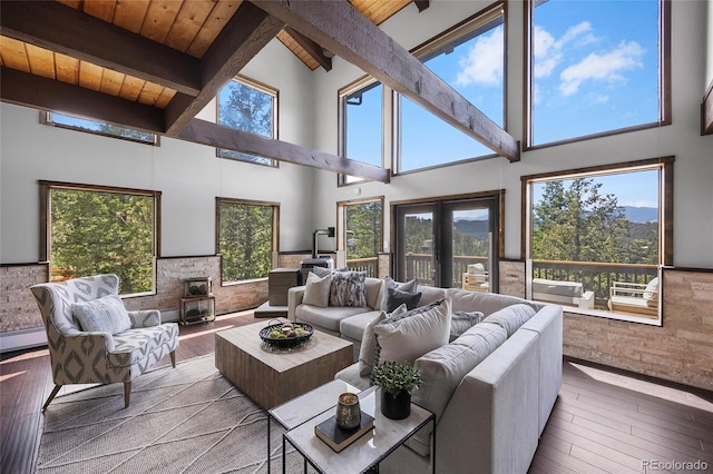 4477 Independence Trl, Evergreen, CO 80439 - living area with a wooden ceiling with exposed beams, high vaulted ceiling, hardwood / wood-style floors, and a wood stove