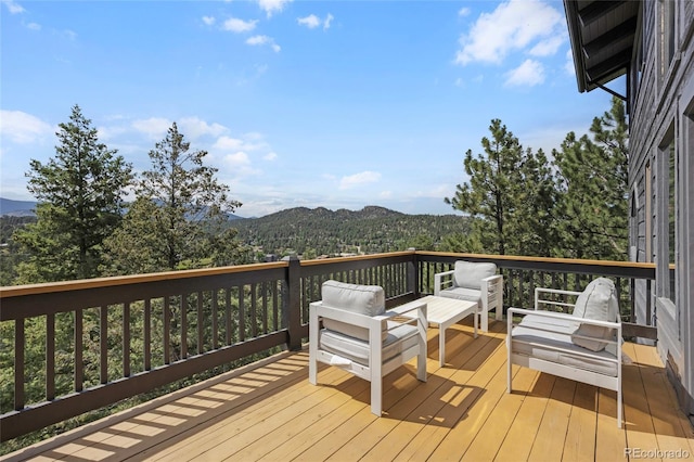 4477 Independence Trl, Evergreen, CO 80439 - wooden deck featuring a mountain view and an outdoor hangout area
