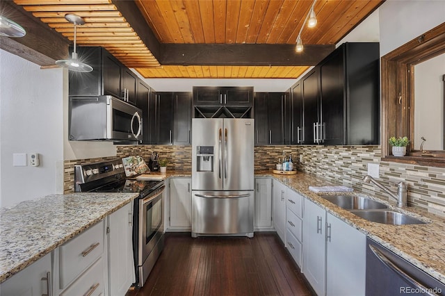 4477 Independence Trl, Evergreen, CO 80439 - kitchen featuring appliances with stainless steel finishes, a wooden ceiling with exposed beams, dark wood-style floors, tasteful backsplash, and light stone countertops