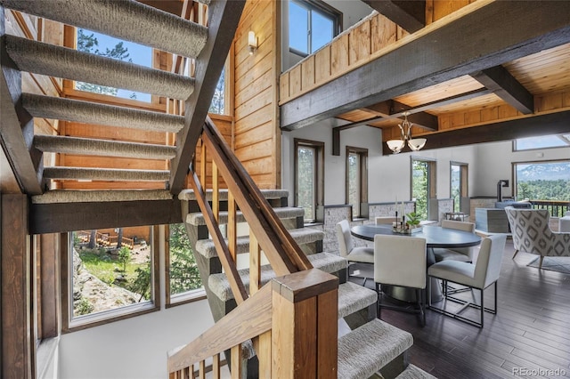 4477 Independence Trl, Evergreen, CO 80439 - dining room with stairway, beamed ceiling, a chandelier, dark wood-style floors, and a towering ceiling