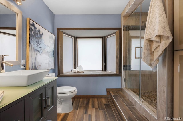 4477 Independence Trl, Evergreen, CO 80439 - bathroom featuring double vanity, a stall shower, and wood finished floors