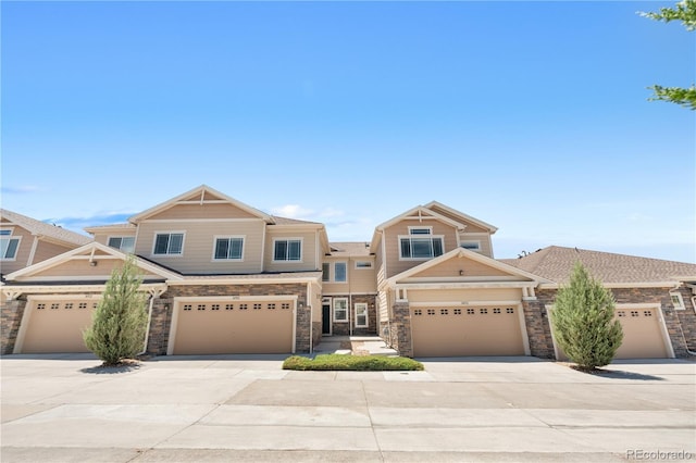 14892 E Poundstone Dr, Aurora, CO 80015 - view of front of house with stone siding, driveway, and a garage
