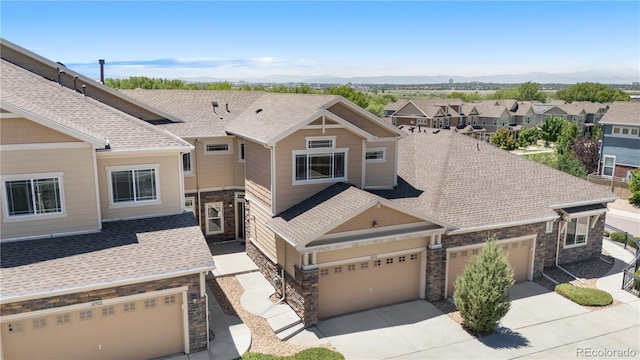 14892 E Poundstone Dr, Aurora, CO 80015 - craftsman inspired home featuring stone siding, concrete driveway, and roof with shingles