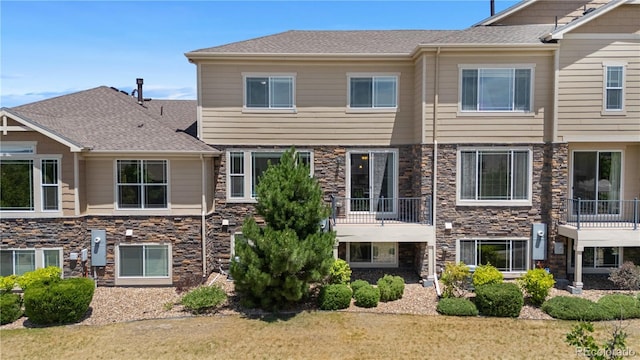 14892 E Poundstone Dr, Aurora, CO 80015 - back of property featuring stone siding and a balcony