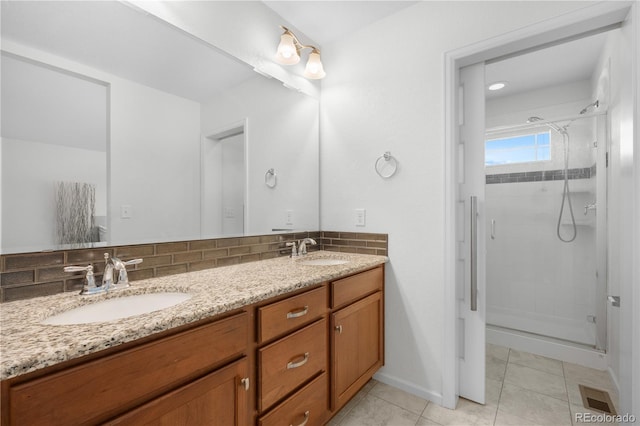 14892 E Poundstone Dr, Aurora, CO 80015 - bathroom with a stall shower, double vanity, decorative backsplash, and tile patterned floors
