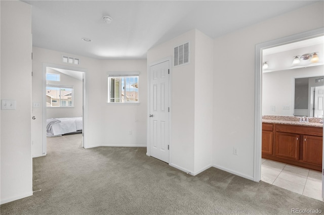 14892 E Poundstone Dr, Aurora, CO 80015 - unfurnished bedroom featuring light carpet and connected bathroom