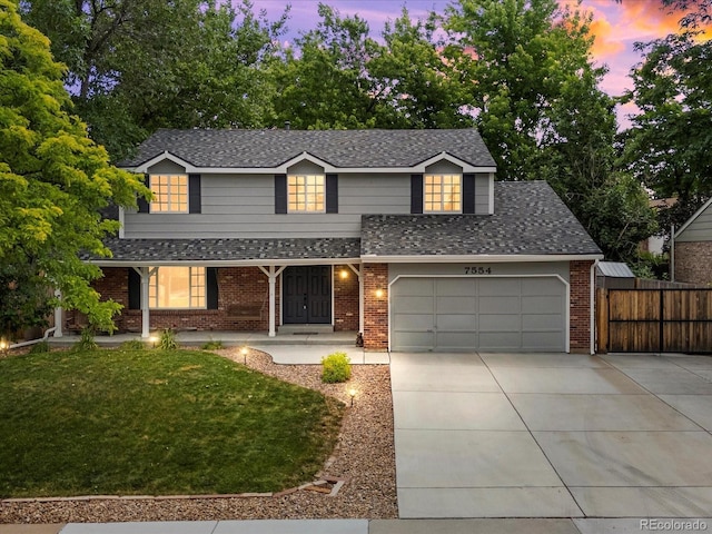 7554 S Ogden Way, Centennial, CO 80122 - traditional-style house with concrete driveway, roof with shingles, covered porch, and brick siding