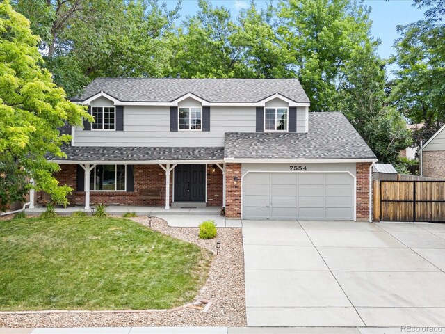 7554 S Ogden Way, Centennial, CO 80122 - traditional-style house featuring concrete driveway, roof with shingles, a porch, brick siding, and a garage