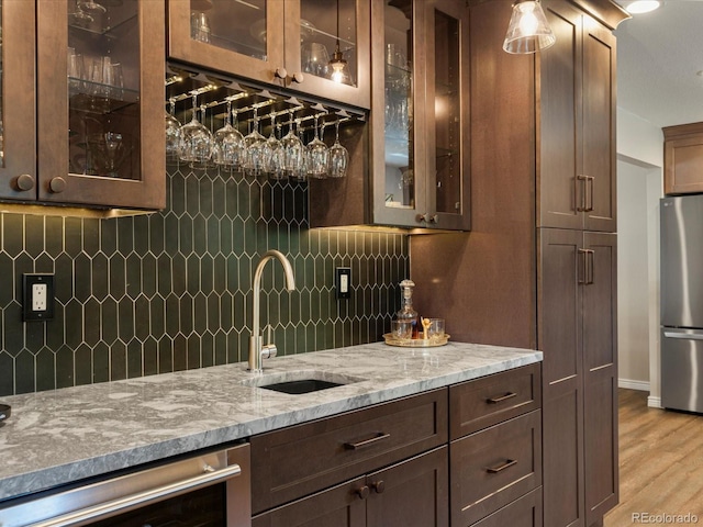 7554 S Ogden Way, Centennial, CO 80122 - indoor wet bar featuring freestanding refrigerator, tasteful backsplash, light wood-type flooring, and dishwasher