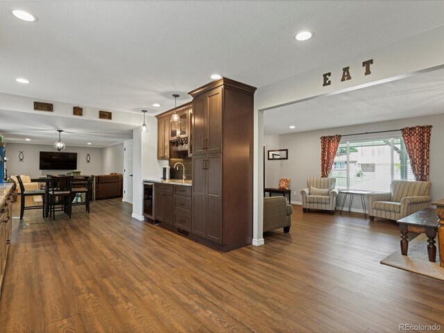 7554 S Ogden Way, Centennial, CO 80122 - kitchen featuring open floor plan, dark wood-style floors, recessed lighting, beverage cooler, and dark brown cabinets