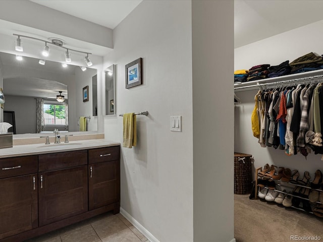 7554 S Ogden Way, Centennial, CO 80122 - bathroom with vanity, ceiling fan, a spacious closet, rail lighting, and tile patterned flooring