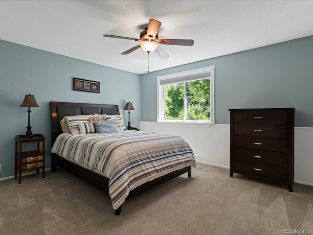 7554 S Ogden Way, Centennial, CO 80122 - bedroom with a wainscoted wall, carpet flooring, and ceiling fan