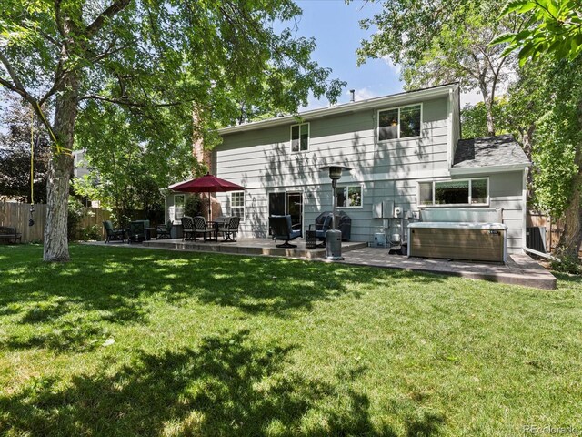 7554 S Ogden Way, Centennial, CO 80122 - back of house with a hot tub and a patio