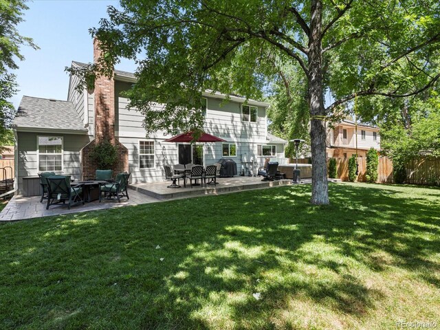 7554 S Ogden Way, Centennial, CO 80122 - back of house with a patio and a chimney
