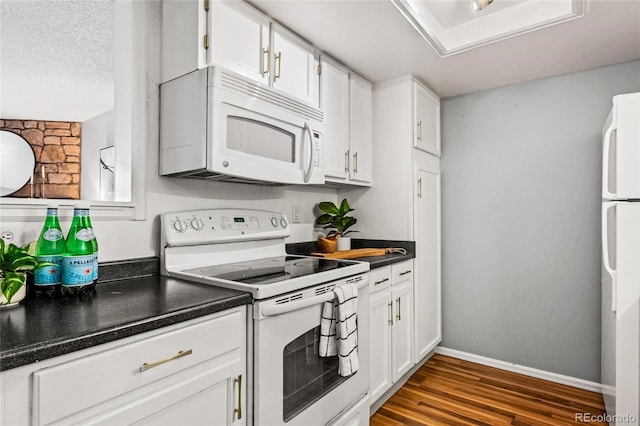 kitchen featuring white appliances, dark wood-type flooring, white cabinets, and a textured ceiling