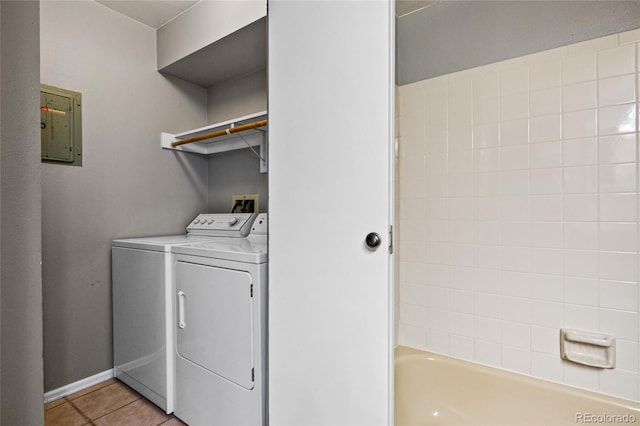 laundry area featuring separate washer and dryer, light tile patterned floors, and electric panel