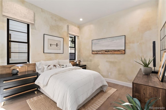 bedroom with dark hardwood / wood-style flooring