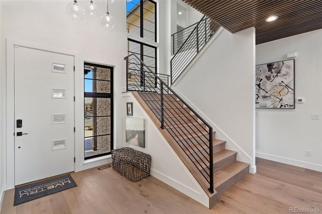 foyer with hardwood / wood-style flooring and a high ceiling