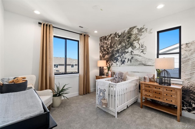 carpeted bedroom featuring multiple windows