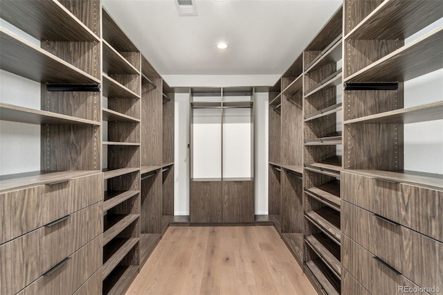 spacious closet featuring light hardwood / wood-style floors