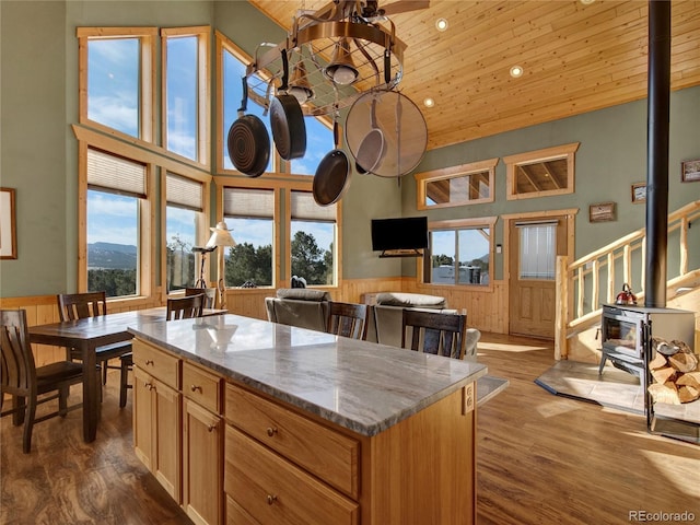 kitchen with a kitchen island, high vaulted ceiling, light stone countertops, dark wood-type flooring, and wooden ceiling