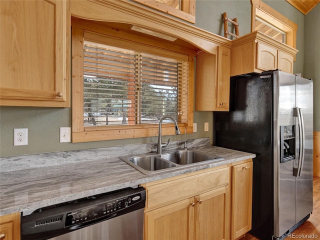 kitchen featuring light brown cabinetry, sink, and stainless steel appliances