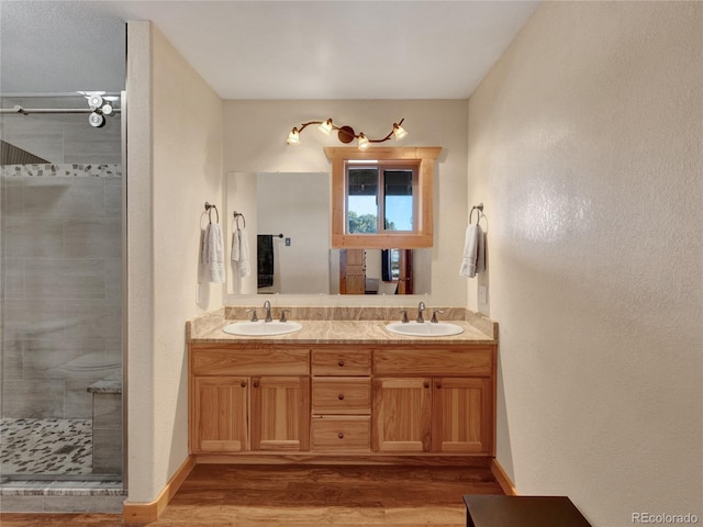 bathroom with vanity, hardwood / wood-style floors, and a shower with shower door