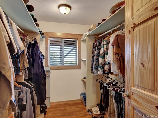 walk in closet featuring light hardwood / wood-style flooring