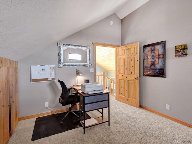 home office featuring lofted ceiling and carpet