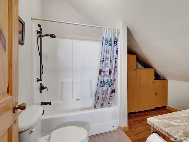 full bathroom with hardwood / wood-style floors, lofted ceiling, shower / bath combination with curtain, vanity, and toilet