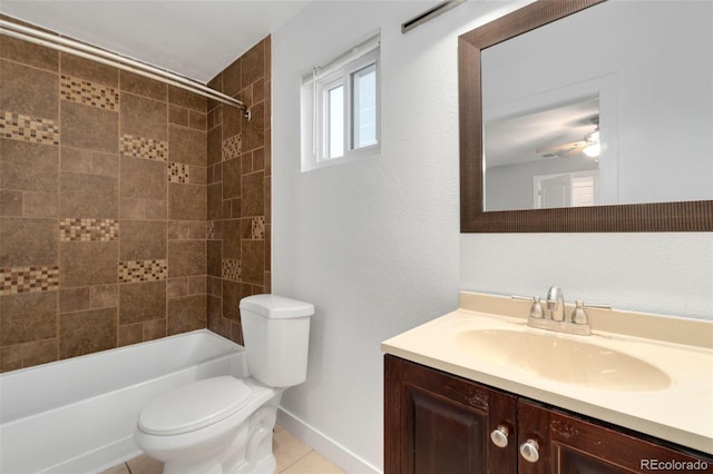 full bathroom with ceiling fan, vanity, tile patterned flooring, toilet, and tiled shower / bath