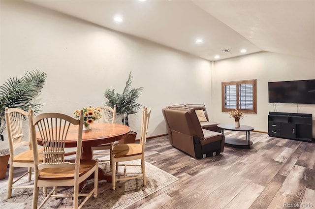 dining room featuring baseboards, visible vents, wood finished floors, vaulted ceiling, and recessed lighting