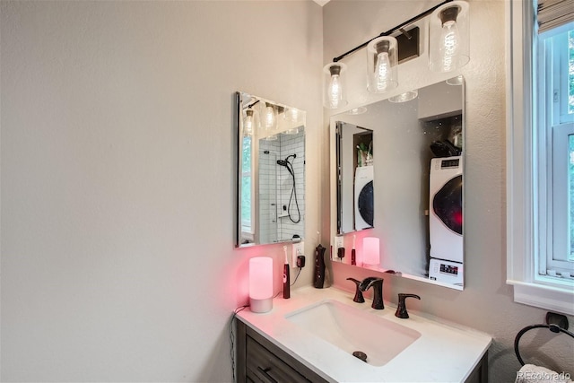 bathroom featuring vanity and washer / dryer