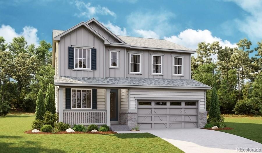 view of front of property with a garage and a front lawn