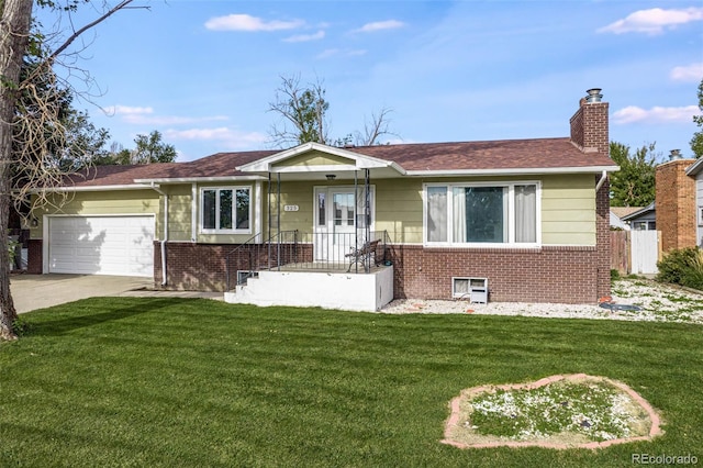 view of front of home with a garage, brick siding, driveway, a chimney, and a front yard