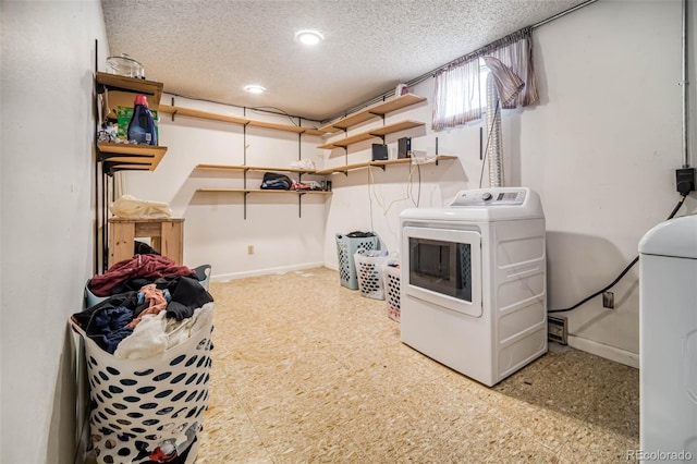 laundry room featuring a textured ceiling and washer / dryer