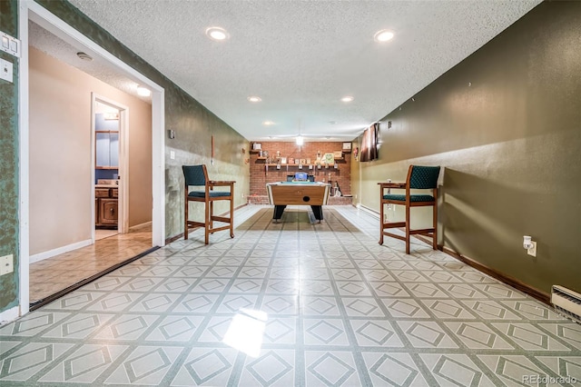 interior space with a textured ceiling and pool table