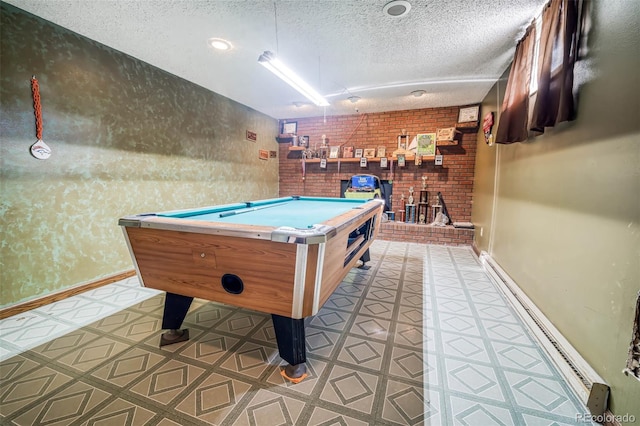 playroom with brick wall, a textured ceiling, and billiards