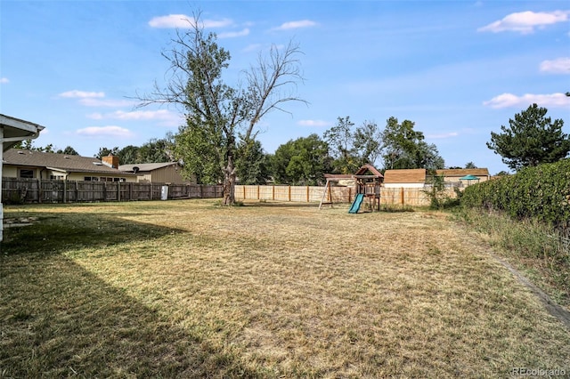 view of yard featuring a playground and a fenced backyard