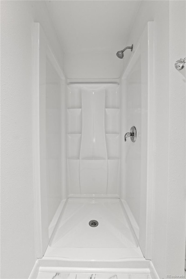 full bath featuring a shower stall