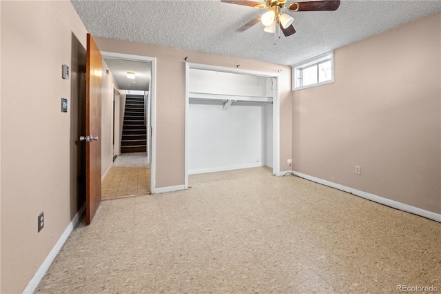 unfurnished bedroom featuring a textured ceiling, baseboards, and tile patterned floors