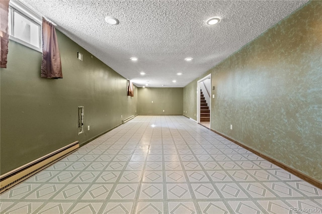 finished below grade area with recessed lighting, stairway, baseboard heating, a textured ceiling, and baseboards