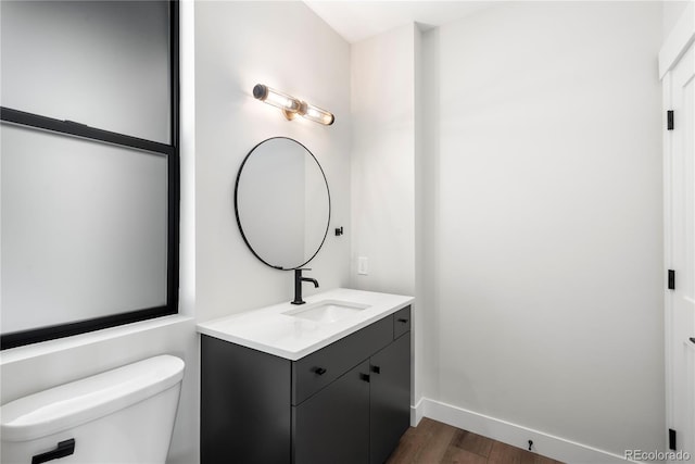 bathroom featuring hardwood / wood-style flooring, vanity, and toilet