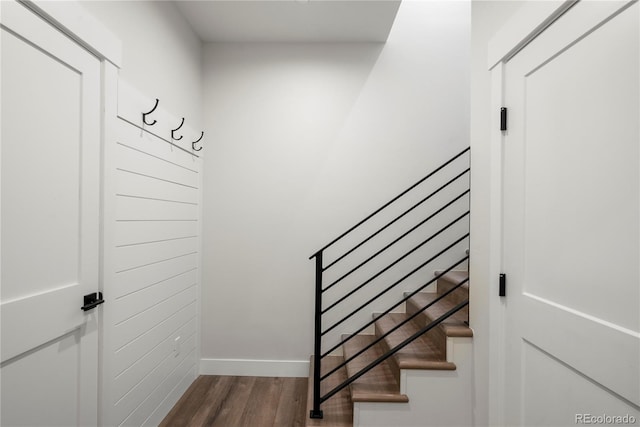 stairway with hardwood / wood-style floors