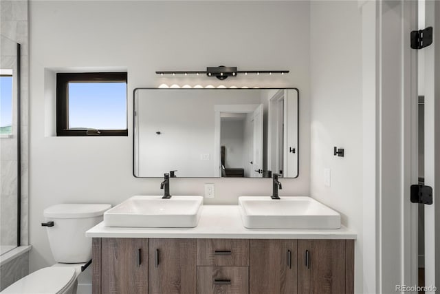 bathroom featuring vanity and toilet