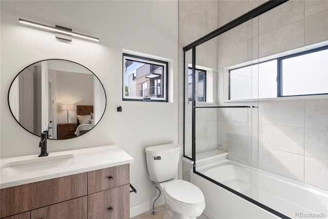 full bathroom featuring vanity, toilet, and enclosed tub / shower combo