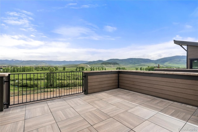 view of patio featuring a mountain view and a balcony