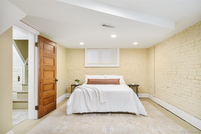 bedroom with baseboards, brick wall, visible vents, and recessed lighting