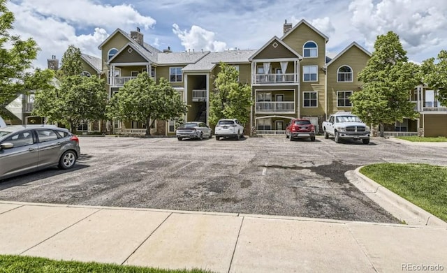 view of building exterior featuring uncovered parking